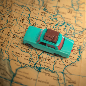 Blue toy car on a map